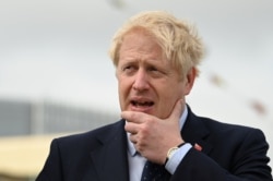 Britain's Prime Minister Boris Johnson visits the NLV Pharos, a lighthouse tender moored on the river Thames to mark London International Shipping Week in London, Britain, Sept. 12, 2019.