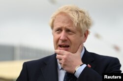Britain's Prime Minister Boris Johnson visits the NLV Pharos, a lighthouse tender moored on the river Thames to mark London International Shipping Week in London, Britain, Sept. 12, 2019.