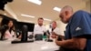 Alex Domino, right, the first ever person to legally receive medical marijuana in Louisiana, purchases his dose at Capitol Wellness Solutions, in Baton Rouge, Louisiana, Aug. 6, 2019.