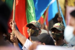 Supporters of Myanmar's military take part in a protest against election results, in Yangon, Myanmar, Jan. 30, 2021.