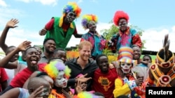 Youths pose for a photograph with Britain's Prince Harry during his visit to Circus Zambia in Lusaka, Zambia, Nov. 27, 2018. 