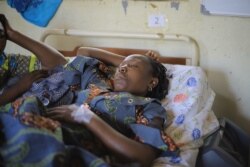 Esperance, 75, sits in bed at the General Referral Hospital in Beni, June 27, 2021, after a makeshift bomb exploded inside the Emmanuel Butsili Catholic Church.