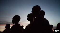 FILE - Young residents watch a screening of the Central African Ambulant Cinema in Bayanga, November, 2, 2018. 
