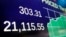 A board above the trading floor of the New York Stock Exchange shows the Dow Jones industrial average closing number above 21,000, March 1, 2017.
