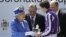 Britain's Queen Elizabeth II presents the trophy to the winning jockey of the Diamond Jubilee Coronation Cup race, June 2, 2012