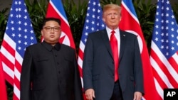 FILE - U.S. President Donald Trump, right, meets with North Korean leader Kim Jong Un on Sentosa Island, in Singapore, June. 12, 2018. 