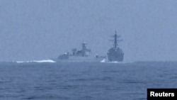 (FILE) A PRC warshipcrosses the path of U.S. Navy destroyer USS Chung-Hoon as it was transiting the Taiwan Strait with the Royal Canadian Navy frigate HMCS Montreal on June 3, 2023.