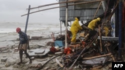 Bangladeshi rescue workers search for survivors after Cyclone Roanu hit Chittagong, May 21, 2016. Cyclone Roanu struck the Bangladesh coast forcing hundreds of thousands to flee their homes as the storm unleashed strong winds and heavy rains. 