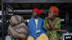 Ethiopian returnees wait in line to get their temporary IDs at the International Organization for Migration (IOM) transit center in Addis Ababa on November 25, 2023, the day after 86 migrants made their way back to Ethiopia from Djibouti.