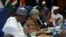 Nigeria's President Muhammadu Buhari, left, Liberia's President Ellen Johnson Sirleaf, center, and Marcel de Souza, president of the ECOWAS Commission, attend the Ordinary Session of the ECOWAS Heads of State and Government in Abuja, Nigeria, Dec. 17, 2016.