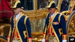 FILE- Footmen walk alongside the Golden Carriage as Netherlands' King Willem-Alexander and Queen Maxima arrive at Noordeinde Palace, Netherlands, Sept. 17, 2013. 