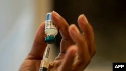 FILE - A nurse prepares the measles, mumps and rubella vaccine at the Rockland County Health Department in Haverstraw, Rockland County, New York, April 5, 2019. A measles outbreak in west Texas has infected 48 people, according to official state data released on Feb. 14, 2025.