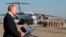 FILE - Russian President Vladimir Putin addresses the troops at the Hemeimeem air base in Syria, Dec. 11, 2017.