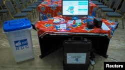 FILE - An electronic voting machine and a ballot box are seen inside the Congo's electoral commission (CENI) head offices at the Gombe Municipality in Kinshasa, Democratic Republic of Congo, March 1, 2018. 