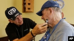 FILE -- Caregiver Warren Manchess, 74, left, shaves Paul Gregoline, 92, in Noblesville, Indiana.