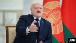 (FILES) Belarus' President Alexander Lukashenko speaks as he meets with foreign media at his residence, the Independence Palace, in the capital Minsk on February 16, 2023.