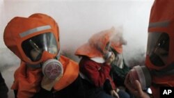South Korean middle school students learn how to use gas masks in a supposed chemical attack in Seoul, as tensions rise with North Korea, Nov. 30, 2010.