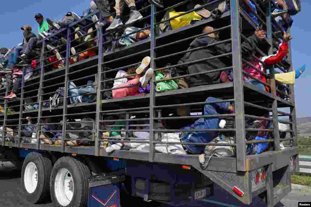 Migrants, part of a caravan of thousands traveling from Central America en route to the United States, travel inside a chicken truck as they make their way to Irapuato from Queretaro, Mexico, Nov. 11, 2018.