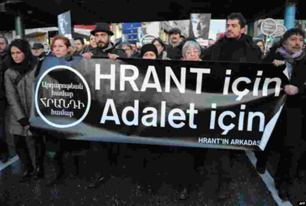 Hundreds of protesters hold a banner that reads 'for Hrant, for justice' as they shout slogans outside a courthouse in Istanbul, Turkey, Tuesday, Jan. 17, 2012. A Turkish court on Tuesday sentenced a man to life in prison for masterminding the killing of 