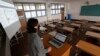 An unidentified teacher gives an online class amid the new coronavirus outbreak at Seoul girls' high school in Seoul, Thursday, April 9, 2020.