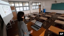 An unidentified teacher gives an online class amid the new coronavirus outbreak at Seoul girls' high school in Seoul, Thursday, April 9, 2020. Senior high school students begin school semester with online classes. Schools remain closed as part of…