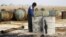 FILE - The Islamic State is funded, in part, through oil. Here, a youth works at a makeshift oil refinery in Syria that, according to its owner, gets the crude oil from Islamic State-controlled areas of Syria and Iraq.