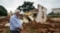FILE - Stephen O’Brien, the U.N.’s top humanitarian official, looks over the main mosque in Bangassou, Central African Republic, that was burned down and destroyed during attacks in May 2017.