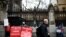 A man passes by pro-Brexit protesters and an anti-Brexit demonstrator outside the Houses of Parliament in London, Britain, March 14, 2019. 
