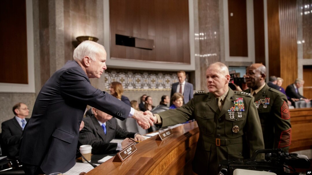Senate Armed Services Committee Chairman Sen. John McCain, R-Ariz., left, welcomes Marine Corps Commandant Gen. Robert B. Neller, center, and Sgt. Major of the Marine Corps Ronald L. Green on Capitol Hill in Washington, Tuesday, March, 14, 2017, prior to the start of the committee's hearing on the investigation of nude photographs of female Marines and other women that were shared on the Facebook page "Marines United."