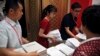 Workers prepare the China's national defense white paper to distribute to the reporters before a press conference at the State Council Information Office in Beijing, July 24, 2019. 