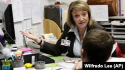 School counselor Roslyn Wagner talks with student Blake Mankin at Cooper City High School in Cooper City, Florida.