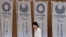 FILE - Tokyo's first woman Governor Yuriko Koike walks past Tokyo 2020 Olympic and Paralympic Games flags as she goes onstage to make a speech at Tokyo Metropolitan Government Building in Tokyo, Japan, August 2, 2016. 