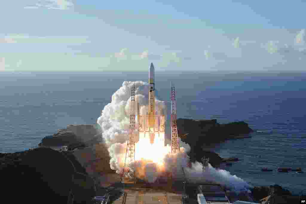 In this photo released by MHI, an H-IIA rocket with United Arab Emirates&#39; Mars orbiter Hope lifts off from Tanegashima Space Center in Kagoshima, southern Japan.