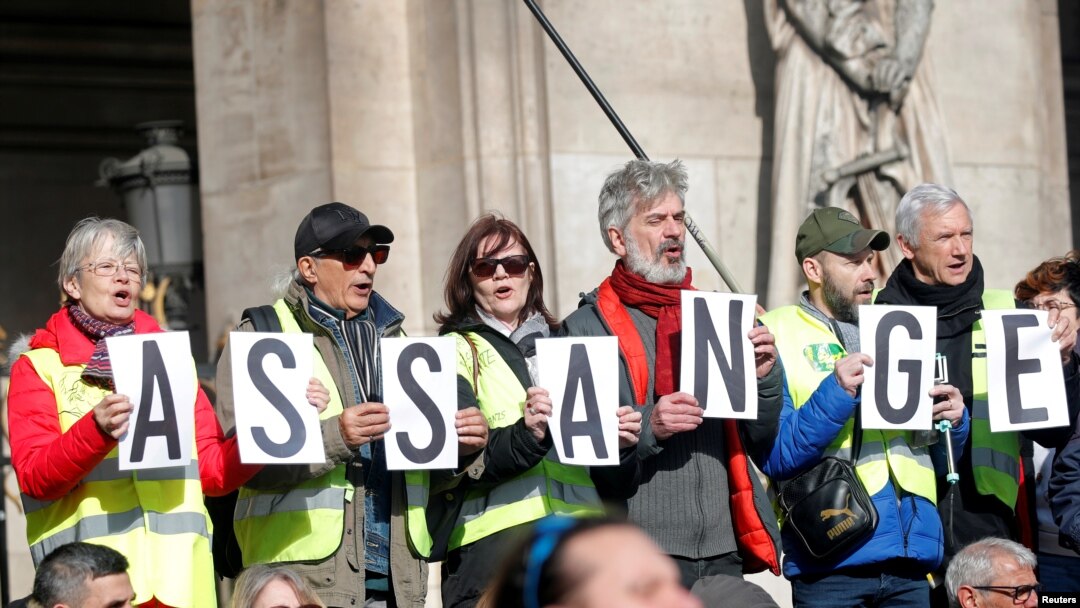 Protesters hold signs demanding freedom for Wikileaks founder Julian Assange in front of the Opera Garnier in Paris, France, Feb. 17, 2020. 