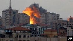 A ball of fire rises from an explosion on al-Zafer apartment tower following an Israeli air strike in Gaza City, in the northern Gaza Strip, Aug. 23, 2014. 