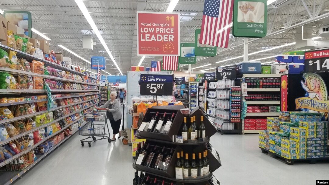 FILE - A shopper is seen in the aisle of a Walmart store in Woodstock, Georgia, June 28, 2018.