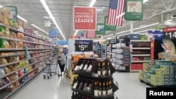 FILE - A shopper is seen in the aisle of a Walmart store in Woodstock, Georgia, June 28, 2018.