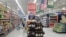 FILE - A shopper is seen in the aisle of a Walmart store in Woodstock, Georgia, June 28, 2018.