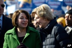 Sens. Amy Klobuchar and Elizabeth Warren on Jan. 20, 2020, as they line up for a Martin Luther King Jr. Day march in Columbia, S.C.