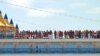 FILE - Passengers of the Costa Deliziosa cruise ship wait to disembark in the port of Genoa, Italy, April 22, 2020.