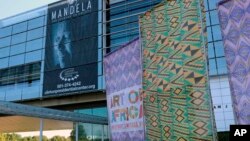 In this Oct. 10, 2017 photo, fabric banners stand in front of the Clinton Presidential Center in Little Rock, Ark. The Clinton Library is presenting "Mandela: The Journey to Ubuntu" and "Art of Africa: One Continent, Limitless Vision" until February. 