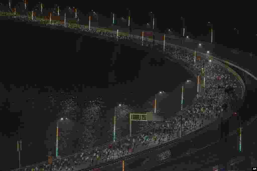 Runners compete along the Bandra-Worli sea link over the Arabian Sea during the Tata Mumbai Marathon in Mumbai, India.