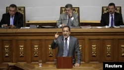 Jose Guerra (C), deputy of the Venezuelan coalition of opposition parties (MUD) and president of the economic special commission, gives a speech during a session of the National Assembly in Caracas, Jan. 22, 2016. 