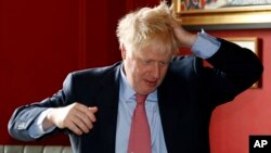 Boris Johnson gestures during a visit to Wetherspoons Metropolitan Bar in London, Wednesday July 10, 2019. (Henry Nicholls/Pool Photo via AP)