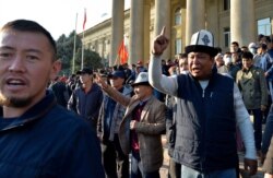 People protest during a rally on the central square in Bishkek, Kyrgyzstan, Oct. 7, 2020. Officials in Kyrgyzstan have nullified the results of a weekend parliamentary election after mass protests erupted in Bishkek and other cities.