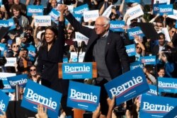 Democratic presidential candidate Sen. Bernie Sanders, I-Vt., right, is introduced by Rep. Alexandria Ocasio-Cortez, D-N.Y., during a campaign rally, Oct. 19, 2019, in the Queens borough of New York.