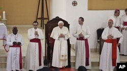 Pope Benedict XVI, center, takes his place as he arrives at the basilica in Ouidah, Benin, November 19, 2011.