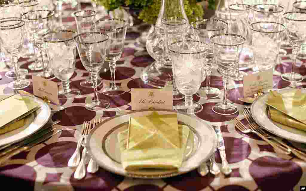 Table settings in the State Dining Room of the White House for the dinner hosted by President Obama and his wife, Michelle, for the British prime minister. (AP)