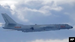 In this photo released by the Taiwan Ministry of National Defense, a Chinese People's Liberation Army H-6 bomber fitted with the YJ-12 anti-ship cruise missile is seen flying near the Taiwan air defense identification zone near Taiwan on Friday,…