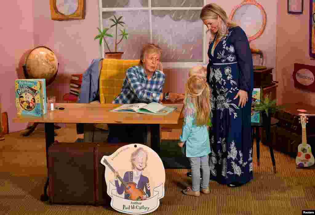 Former member of The Beatles Paul McCartney signs copies of his book &quot;Hey Grandude!&quot; at a launch event in London, Britain.